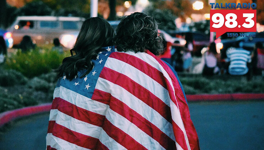 Woman and man covered up in American flag